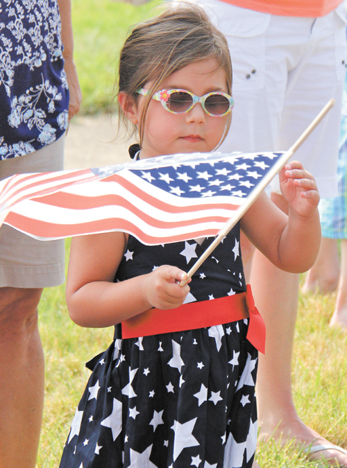4-year-old Olivia Brugnoni of Boardman waves a flag while watching the Memorial Day parade in Boardman.