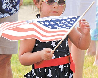4-year-old Olivia Brugnoni of Boardman waves a flag while watching the Memorial Day parade in Boardman.