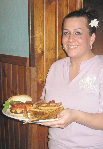 Jackie Metzgar serves up a gourmet burger to the Burger Boys at Mike’s Penn Ave. Grille.