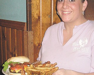 Jackie Metzgar serves up a gourmet burger to the Burger Boys at Mike’s Penn Ave. Grille.