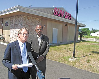 Ohio Attorney General Mike DeWine, left, stands with Warren Mayor Doug Franklin in front of Sun Spa, 2819 W. Market St. NW, just after agents and Warren police raided it and seven other massage parlors Wednesday.