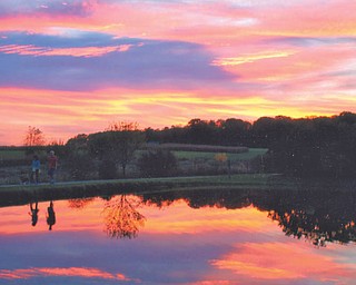 The water's reflections almost makes it looks as if the Canfield Bike Trail cuts through the sky. Photo by Lana Vanauker of Canfield.
