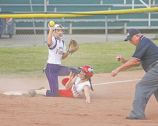 Champion’s Darian Rogers (4) holds up the ball to prove possession after tagging out Felicity-Franklin’s Sandy Woodmansee (1) during the bottom of the first inning of the Division III state softball semifinal Thursday at Firestone Stadium in Akron. The Golden Flashes rallied from a 4-0 deficit to defeat the Cardinals, 6-4.
