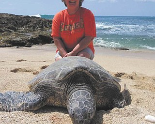 Cathy Ferenchak of Canfield sent in this photo. She's posing with a huge turtle in Hawaii.