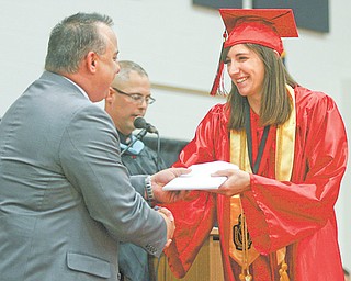 Co-valedictorian Bryanna Jay walks across the stage to receive her diploma during commencement for the Girard High School Class of 2012.