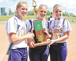 Champion players, from left, Lindsay Swipas, Haley McAllister and Alison Sorber pose with the Division III state championship trophy following the Golden Flashes’ 2-0 win over Bloom-Carroll on Saturday in Akron.
