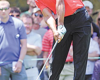 Tiger Woods tees off on the second hole during the final round of the Memorial golf tournament Sunday in
Dublin, Ohio. Woods birdied the hole.