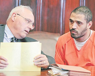 Atty. Gary L. VanBrocklin, left, confers with his client, Milous Brown, in Mahoning County Common Pleas Court. A visiting judge