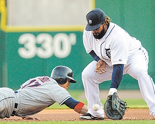 Cleveland Indians’ Shin-Soo Choo (17) safely dives back to the bag under the tag of Detroit Tigers first baseman Prince Fielder during the first inning of Wednesday’s baseball game in Detroit. The Indians won 9-6, improving to 5-0 at Detroit this season.