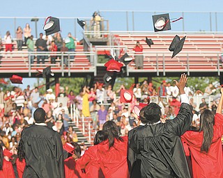 Campbell High School graduates of the class of 2012 throw their caps into the air in celebration at the end of their commencement ceremony.