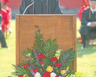 Valedictorian and Class President Thomas Merva, left, gives his speech Thursday during the commencement ceremony for the Campbell Memorial High School Class of 2012 while Kaitlyn Kalicatzaros, right, class salutatorian, receives a trophy. Thomas also was president of the National Honor Society and received an honors diploma and the Award of Merit for his academics. Kaitlyn’s trophy was for her $15,000 renewable scholarship and other academic achievements. She also earned an honors diploma and an Award of Merit.