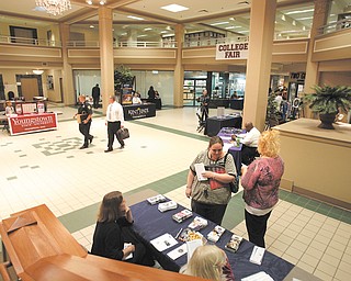 The lobby of 20 Federal Place in downtown Youngstown was the scene for a college fair to attract students and inform them about education opportunities. Dawn Douglas and Shaclecha Stoddard visited the ETI Technical College table on Thursday staff ed by Charlotte Stahl, far left, and Kathy Christi.