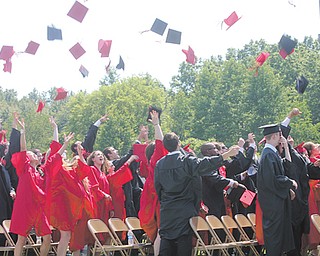 Members of the Canfield High School Class of 2012 throw their caps in elation during commencement exercises
Sunday afternoon at the stadium.