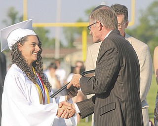 Madison Groner, one of the top 10 students in the 2012 Springfield Local High School Class of 2012, receives her diploma Sunday at the school’s commencement.