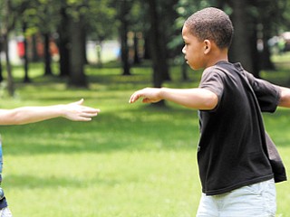 Nathan Wilson, 6, left, and Andrei Wilder, 7, play a game during summer camp in Roosevelt Park in Campbell. Tuesday was the first day of the camp, which is open to kids in kindergarten through sixth grade.