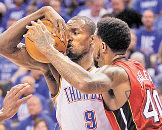 Thunder power forward Serge Ibaka (9) is defended by Heat power forward Udonis Haslem during Tuesday’s Game 1 of the NBA Finals in Oklahoma City, Okla.