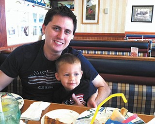 Justin Simerlink and his son Colin, both of Poland, share a pancake breakfast before the Memorial Day parade. From what he eats to what he wears, Colin always wants to be just like Daddy.