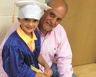 A proud Jim Lipjanic poses with his son, 4-year-old Jimmy Lipjanic, at Jimmy's pre-kindergarten graduation. They are from Boardman.