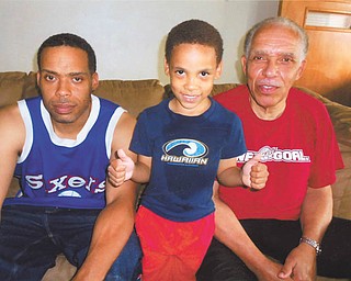 Tariq H. Truman of Youngstown gives a proud thumbs-up to his father, David A. Truman of Youngstown, left, and his grandfather (whom he calls Papa), David M. Truman of Boardman. Photo sent in by David M. Truman.