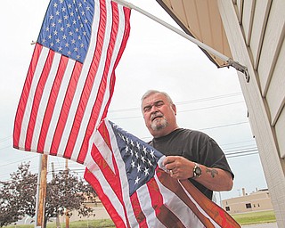 Ron Craig, owner of Western Reserve Flag Co. on Stadium Drive, sells only American-made flags. Today is Flag Day.