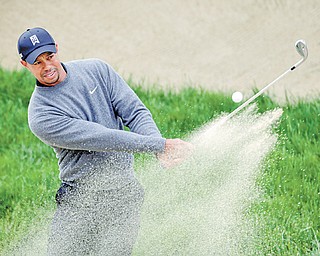 Tiger Woods hits out of a bunker on the second hole during a practice round for the U.S. Open Championship golf tournament Wednesday at The Olympic Club in San Francisco.