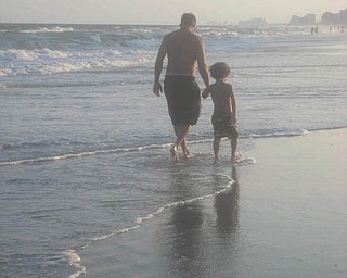 Tony Perry walks along the beach with his son Anthony. They live in Salem. Photo sent in by Allyson Perry.