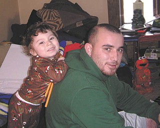 Rob Ginocchi was putting together the train Santa left for his son Pierson on Christmas morning 2011 when this picture was taken. They are from Girard. Photo sent in by Adriana Ginocchi.