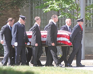 Pallbearers carry the coffin of Warren firefighter Marc Titus into the W.D. Packard Music Hall in Warren. Bugler Garey Watson, top, played taps during the funeral Thursday. Titus, 46, of Cortland, died a week ago in a motorcycle crash on state Route 11 near the King-Graves Road overpass.