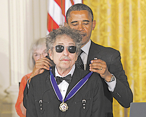 President Barack Obama presents rock legend Bob Dylan with a Medal of Freedom on May 29 at the White House.