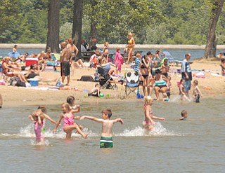 People enjoy themselves at Lake Milton State Park to beat the heat as temperatures rose to the 90s Tuesday. Summer officially starts at 7:09 p.m. today.