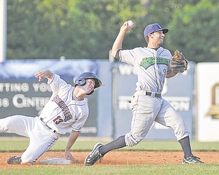 Jamestown Jammers shortstop Anthony Gomez (9) prepares to throw to first base to complete the double play after forcing out Mahoning Valley Scrappers baserunner Joseph Wendle (13) during Wednesday’s New York-Penn League game at Eastwood Field in Niles. The Scrappers won 2-1 in the 11th inning when Wendle was walked in by Jammers relief pitcher Bryan Berglund.