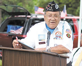 Commander John Pariza of the Korean War Veterans Association of Mahoning Valley Chapter 137 makes opening remarks at Veterans Park at Wickliffe Circle in Austintown on Sunday during the Korean War Veterans’ Laying of the Roses ceremony.