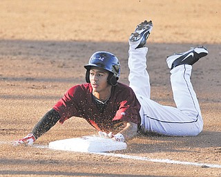 Scrappers baserunner Jairo Kelly slides safely into third base to complete a triple in the bottom of the third inning of Monday’s game at Eastwood Field.