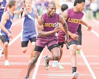 Liberty’s Marquis Williamson takes the baton from teammate Frank Bond for the final leg of the 4x400-meter relay at the state track and field meet on June 2 at Jesse Owens Stadium in Columbus. Williamson is headed
to Youngstown State on a track scholarship.