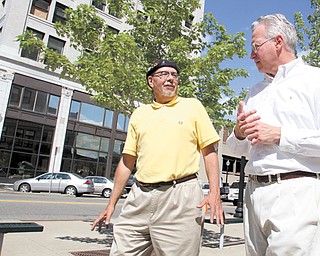 Ron Faniro, left, a local architect, talks with Ed Jerse, director of the Regional Collaboration of Cuyahoga County, during a walking tour of downtown Youngstown. Faniro, of Faniro Architects, served as tour guide Tuesday for members of the Northeast Ohio Sustainable Communities Consortium, who visited portions of the city to get a better understanding of Youngstown.
