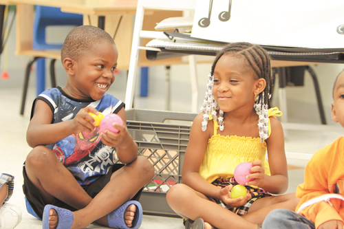 Jeremiah Payne, left, and Aniya Pilson, both 5, share a few laughs playing with stress balls at a Success By Six event at Williamson Elementary School in Youngstown. The youngsters learned Wednesday what is necessary to become good students and citizens.