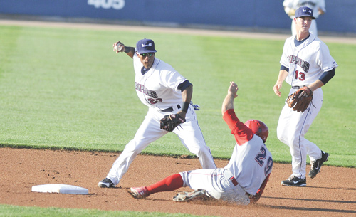 Scrappers shortstop Robel Garcia steps on second and avoids the slide from Crosscutters baserunner Brian Pointer during the first inning of Wednesday’s game at Eastwood Field.