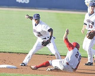 Scrappers shortstop Robel Garcia steps on second and avoids the slide from Crosscutters baserunner Brian Pointer during the first inning of Wednesday’s game at Eastwood Field.