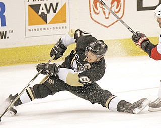 Pittsburgh Penguins’ Sidney Crosby shoots the puck from a split after getting by Ottawa Senators’ Chris Phillips in the second period of the NHL playoff game in Pittsburgh. Crosby, 24, agreed Thursday to a 12-year contract extension with the Penguins, leaving little doubt that he has overcome concussion like symptoms that sidelined him for most of the last two seasons.