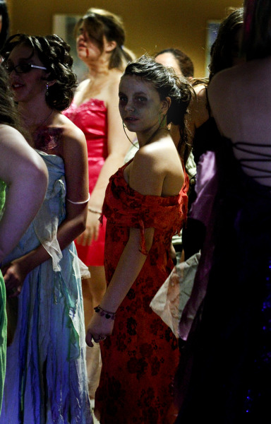MADELYN P. HASTINGS..Tristin Moncrief, 12, of Struthers, Ohio stands in a group of zombies during the 'Zombie Prom' in the Poland Library on June 28, 2012. The girls dressed in glamorous gowns, most of which, were torn to shreds.