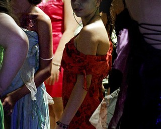 MADELYN P. HASTINGS..Tristin Moncrief, 12, of Struthers, Ohio stands in a group of zombies during the 'Zombie Prom' in the Poland Library on June 28, 2012. The girls dressed in glamorous gowns, most of which, were torn to shreds.