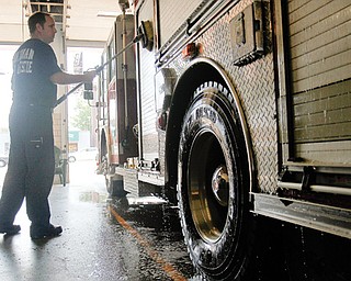 Firefighter Scot Murray of Boardman washes a firetruck at the Boardman Fire Department. The firefighters are
taking extra care to prepare for the busy holiday weekend. Firefighters say the region’s dry conditions and use of
fireworks can bring disastrous results.