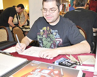 A.J. Sabino of Kent works on a drawing from the cartoon “Adventure Time” during Sunday’s All Americon 2012 event at the Comfort Inn in Warren.