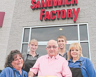 From left, longtime workers Sonya Shar and Monique Stilson, along with sandwich Factory owner Joe Loree and
employees Bryan Emborsky and Sue Eckert, show off one of the restaurant’s big subs.