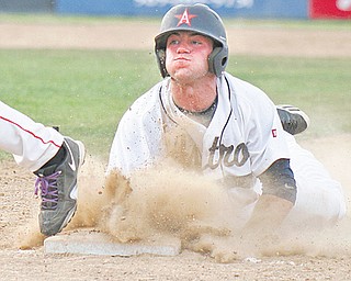The Astro Falcons’ James Coates dives back to the base ahead of the tag by Creekside Fitness first baseman Hank Schlueter in the first inning during Game 2 of the Class B baseball championship Wednesday at Cene Park in Struthers. Astro led Creekside, 3-1, before the game was suspended by lightning in the bottom of the fifth.