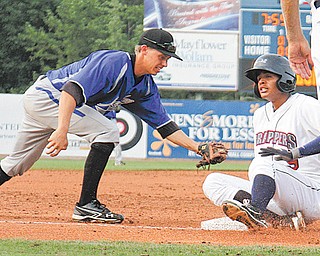 Scrappers baserunner Erik Gonzales slides into third base under the tag by the IronBirds’ Anthony Caronia during their New York-Penn League game Wednesday at Eastwood Field in Niles. After a rain delay in the top of the ninth inning, the IronBirds rallied to win, 3-1.