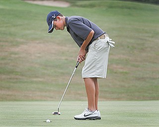 Cory Stefanec, 17, of Cardinal Mooney High School, sinks a putt on the 18th hole at Diamond Back Golf Course in Canfield, during the boys’ qualifier Thursday for The Greatest Junior Golfer of the Valley golf tournament. Four more golfers advanced to the finals, which will be July 21 at Trumbull Country Club.
