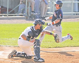 Scrappers catcher Jeremy Lucas can’t snag the baseball while Connecticut Tigers baserunner Jordan Dean prepares to slide into home for the Tigers’ first run in the top of the third inning. Mahoning Valley won 5-4 in 11 innings.