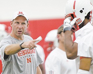 Nebraska head coach Bo Pelini, left, has 16 starters returning from last year’s 9-4 team and is excited about his team’s prospects this season. He’s not as thrilled about college football’s new four-team playoff.