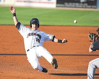 Scrappers baserunner Evan Frazar slides into third base while Connecticut third baseman Tyler Hanover waits to field the ball during Monday’s game at Eastwood Field.